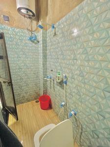 a bathroom with a shower with a toilet in it at My Perfect Stay in Ayodhya