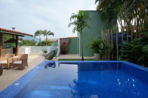 a large blue swimming pool in a house at Casa Varanda Guaecá Pet Friendly, Heated Pool in São Sebastião