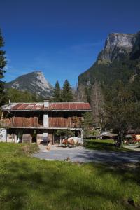 a large building with a mountain in the background at Gite des deux fontaines in Samoëns