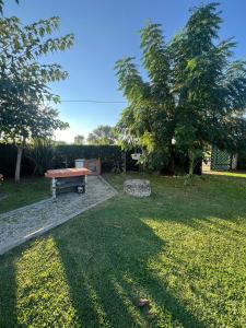a park with a picnic table and a tree at Chalet del mare in Lido di Latina 