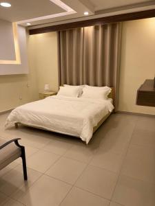 a bedroom with a large bed with white sheets at منتجع تالابيه العقبة in Aqaba +9 photos