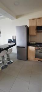 a kitchen with a refrigerator and a desk in it at منتجع تالابيه العقبة in Aqaba