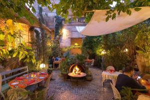 a patio with a fire pit in a garden at Charming Moroccan Guest House with Patio & Terrace in Fès