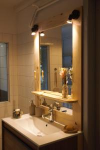 a bathroom with a sink and a mirror at Gite des deux fontaines in Samoëns +15 photos