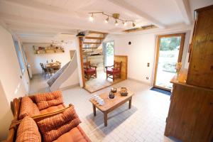 a living room with a couch and a table at Gite des deux fontaines in Samoëns