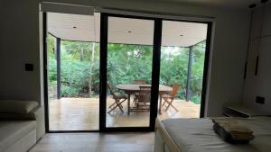 a bedroom with a door open to a patio with a table at Avani in Contadora