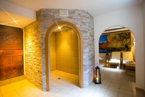 a bathroom with a shower with a stone wall at Residence Remi in Senales +39 photos