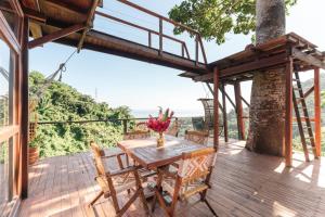 a wooden deck with a table and chairs at Paraiso Ahimsa in Buritaca