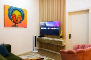 a living room with a flat screen tv at D'Vista Apartments in Ikota