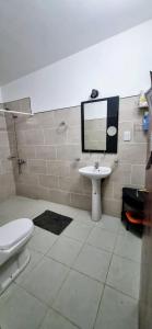 a bathroom with a sink and a toilet and a mirror at Rancho Grande in Santa María