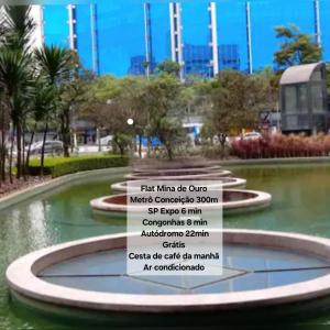 a sign in front of a fountain in a park at Flat Mina de Ouro - Metrô Conceição SP Expo Congonhas Autódromo in Sao Paulo