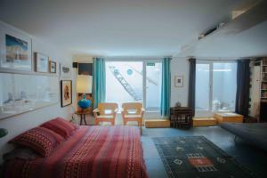a bedroom with a bed and chairs and a window at Spacious Chillout in Madrid in Madrid +38 photos