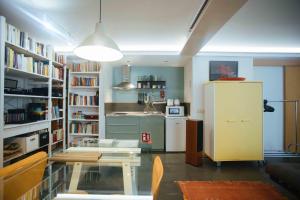a kitchen with a refrigerator in a room with books at Spacious Chillout in Madrid in Madrid