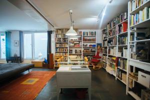 a living room with a couch and bookshelves at Spacious Chillout in Madrid in Madrid