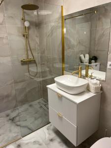 a bathroom with a sink and a shower at Apartament Iulius Mall Cluj in Cluj-Napoca +1 photo
