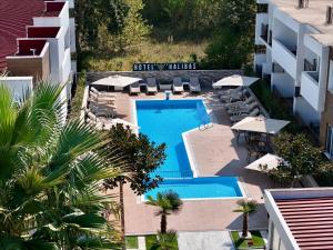an aerial view of a hotel swimming pool with chairs and umbrellas at Hotel Halibas in Ulcinj