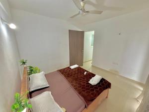 a bedroom with a bed and a ceiling fan at prahi villa 3bhk in Lonavala