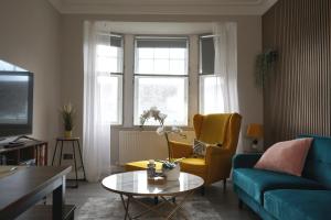 a living room with a couch and a table at Falkirk City Centre Stylish Two-Bedrooms Apartment in Falkirk