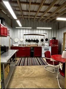 a kitchen with red cabinets and a red table at Angler's Dream Stay! in Hemphill