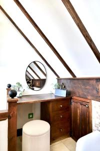 a staircase with a mirror and a stool in a room at Characterful holiday home in Oxfordshire Cotswolds 