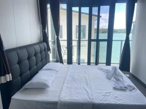 a bed in a room with a large window at lake view apartment 湖畔别墅 in Montmartre +24 photos