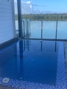 a swimming pool with a view of the water at lake view apartment 湖畔别墅 in Montmartre