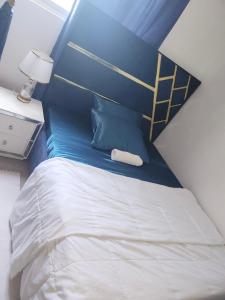 a bedroom with a bed with a blue head board at Rent Mombassa Mtwapa Kenya 2people in Bardejov