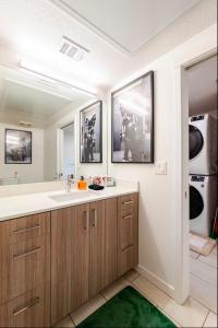 a bathroom with a sink and a large mirror at Modern Mile High in Sloans Lake in Denver
