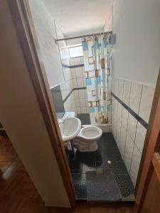 a bathroom with a toilet and a sink at Refugio Sagrado Boutique Ollantaytambo in Ollantaytambo