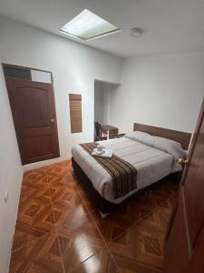 a bedroom with a bed in a room with a door at Refugio Sagrado Boutique Ollantaytambo in Ollantaytambo