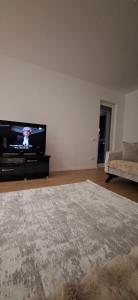 a living room with a flat screen tv and a couch at Blert's apartment in Gjakova in Gjakove