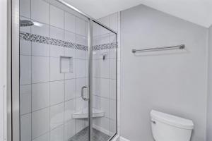 a bathroom with a shower and a toilet at TC5556: 5556 Turtle Cove in Kiawah Island +23 photos