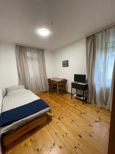 a bedroom with a bed and a desk and a table at Gasthaus Liam 3 in Bendorf
