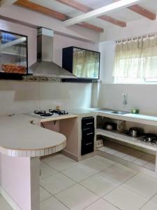 a kitchen with a sink and a counter top at Cabañas Riviera Pacific in Pedernales