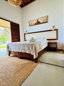 a bedroom with a bed and a large window at Casa Calango suites in Fortim