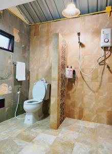 a bathroom with a toilet and a shower at BaanBaimai Homestay in Chiang Rai