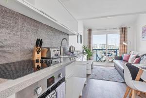 a kitchen and living room with a couch at On the Water 3 with Free Parking By My Getaways in Brighton & Hove +28 photos