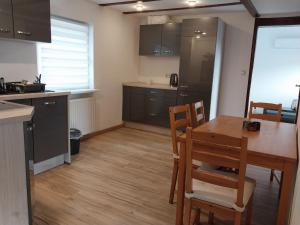a kitchen with a table and chairs in a room at Waldblick in Hirschhorn in Hirschhorn +8 photos
