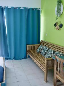 a room with two beds and blue curtains at Studio au soleil, plage privée in Grand-Bourg +21 photos