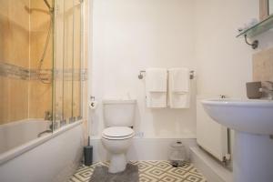 ein weißes Badezimmer mit Toilette und Waschbecken in der Unterkunft Modern 2-Bed Apartment in Central Portsmouth in Portsmouth + 12 Fotos