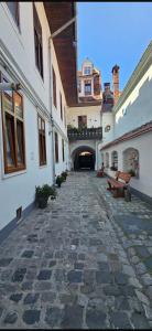 a stone walkway with benches in a building at Tobacco Sforii Residence in Braşov