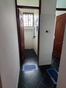 a hallway with a door and a mat on the floor at Zurihomes in Dar es Salaam +5 photos