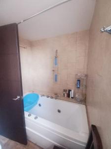 a bath tub in a bathroom with a blue at Casa De la Cruz in Quito +12 photos