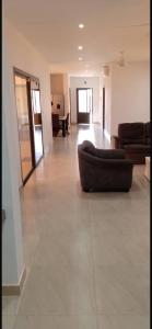 a large living room with a couch in the middle at Villa de luxe à Ngaparou Saly center in Mbour