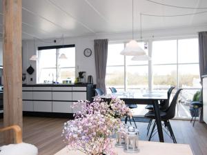 eine Küche und ein Esszimmer mit einem Tisch und Blumen in der Unterkunft 7 person holiday home in Ebeltoft in Ebeltoft