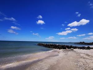 a beach with a bunch of rocks in the water at 8 person holiday home in Sæby-By Traum in Sæby +32 photos