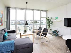 a living room with a couch and a table at Blokhus Holiday Center in Blokhus