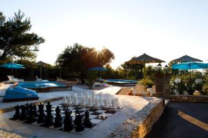 a chess board in front of a swimming pool at Waterman Beach Village in Supetar