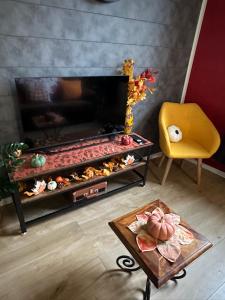 a living room with a fireplace and a yellow chair at Le cocon de Marckolsheim proche Europapark in Marckolsheim +44 photos