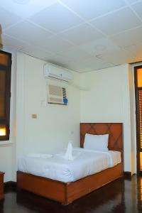 a bedroom with a bed and a air conditioner at King palace castle hotel in Cairo